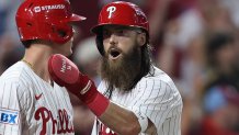 Oct 4, 2025; Philadelphia, Pennsylvania, USA; Philadelphia Phillies center fielder Brandon Marsh (16) reacts with third baseman Alec Bohm (28) after scoring against the Los Angeles Dodgers in the second inning  during game one of the NLDS round for the 2025 MLB playoffs at Citizens Bank Park. Mandatory Credit: Bill Streicher-Imagn Images