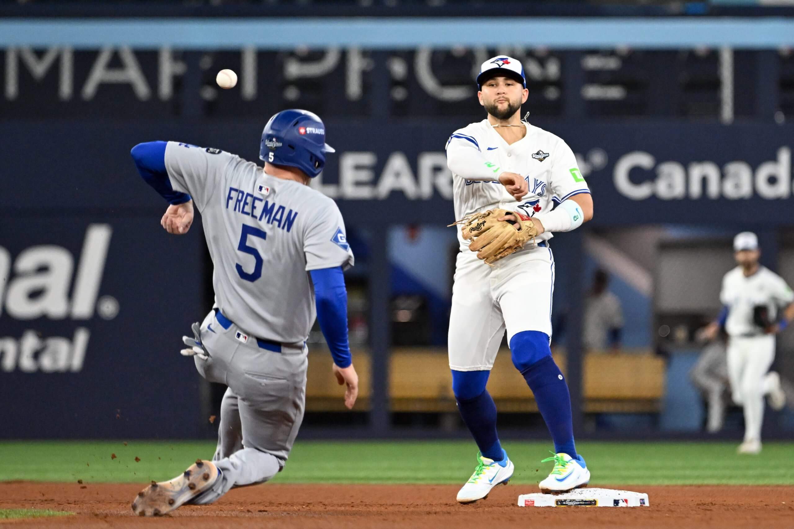 Dodgers first baseman Freddie Freeman (5) is out at second base as Toronto Blue Jays second baseman Bo Bichette (11) attempts to turn a double play in the eighth inning during game two of the 2025 MLB World Series at Rogers Centre. 