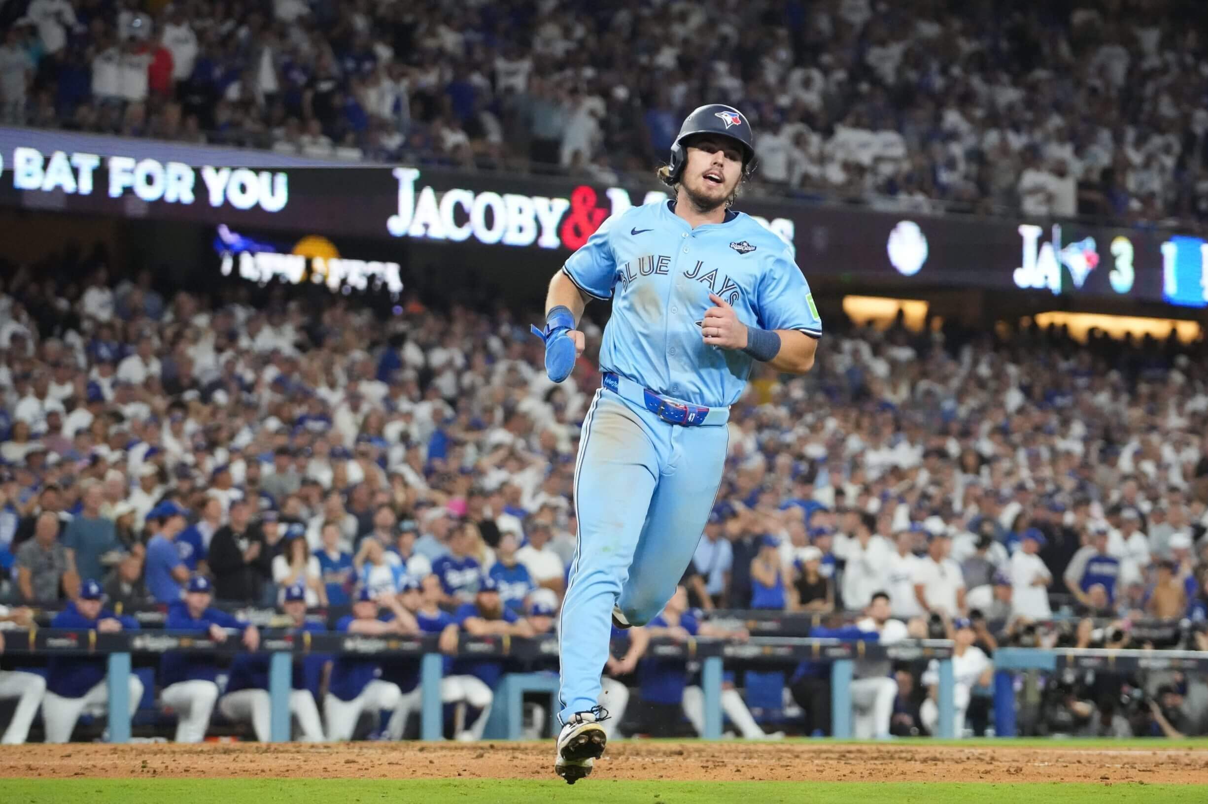 Blue Jays right fielder Addison Barger scores on a wild pitch during Game 5 of the World Series at Dodger Stadium. Kirby Lee / Imagn Images