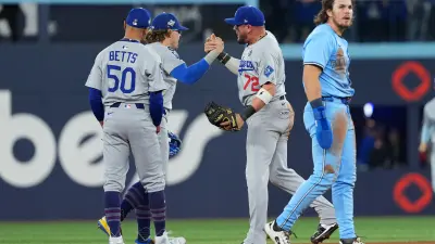 Oct 31, 2025; Toronto, Ontario, CAN; Los Angeles Dodgers first baseman Enrique Hernandez (8), and shortstop Mookie Betts (50) react in the ninth inning for game six of the 2025 MLB World Series at Rogers Centre.