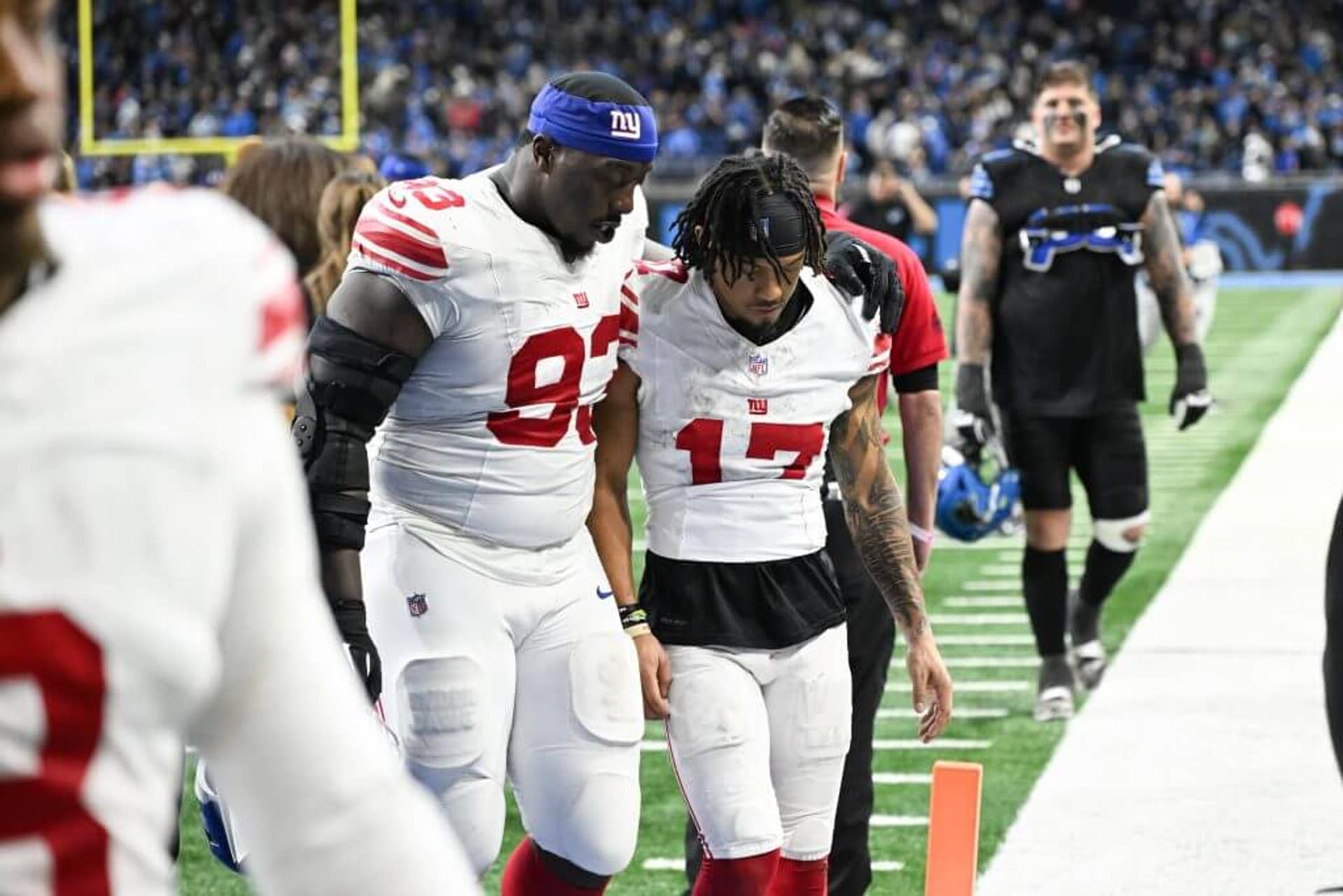 New York Giants defensive lineman Rakeem Nuñez-Roches Sr. (93) and wide receiver Wan'Dale Robinson (17) exit Ford Field after the game against the Detroit Lions.
