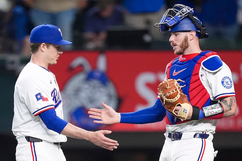 Texas Rangers pitcher Phil Maton celebrated with catcher Jonah Heim after recording the...