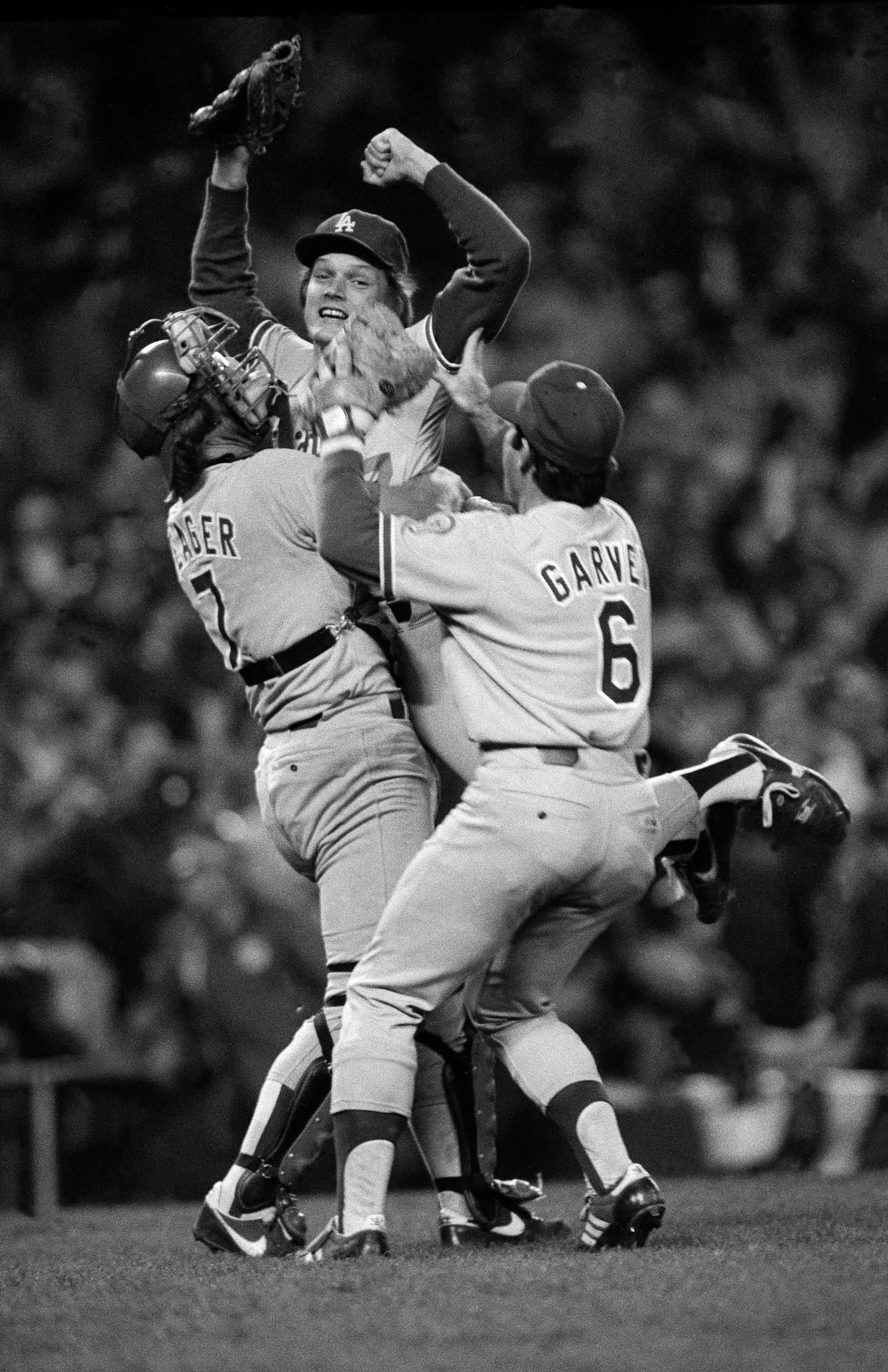 Los Angeles Dodgers, from left: Steve Yeager, Steve Howe and Steve Garvey celebrate their Game 6 defeat of the New York Yankees to win the 1981 World Series, at Yankee Stadium in New York, Oct. 28, 1981. The Yankees and Dodgers, who have met 11 times in the World Series, the most of any two teams, have produced some of baseball’s most memorable moments. (Barton Silverman/The New York Times)
                      
