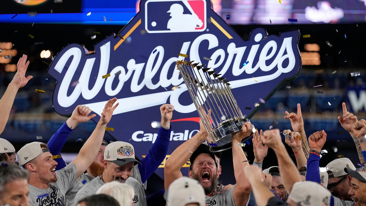 Los Angeles Dodgers pitcher Clayton Kershaw celebrates with the trophy after their win against the Toronto Blue Jays in Game 7 of baseball's World Series, Sunday, Nov. 2, 2025, in Toronto. (AP Photo/Brynn Anderson)