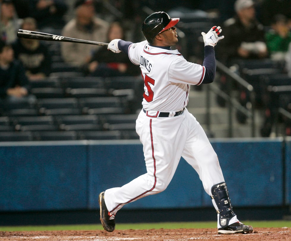 Atlanta Braves' Andruw Jones follows through with a home run swing during a baseball game...