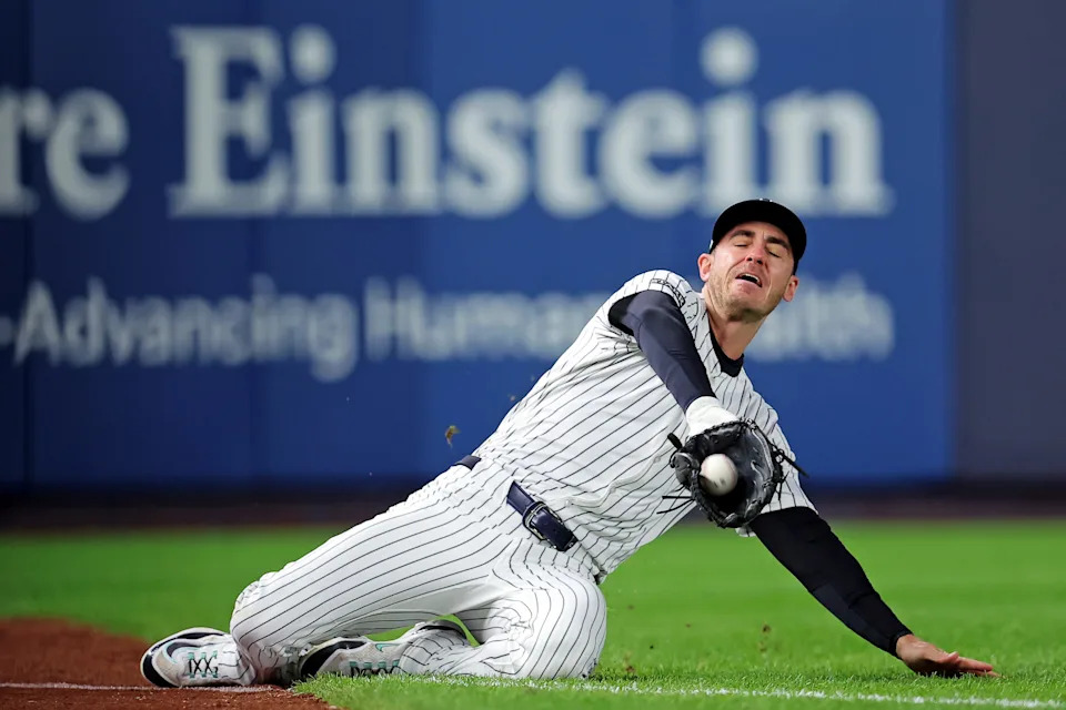 Oct 8, 2025; Bronx, New York, USA; New York Yankees left fielder Cody Bellinger (35) slides to makes a catch during the first inning against the Toronto Blue Jays during game four of the ALDS round for the 2025 MLB playoffs at Yankee Stadium. Mandatory Credit: Brad Penner-Imagn Images