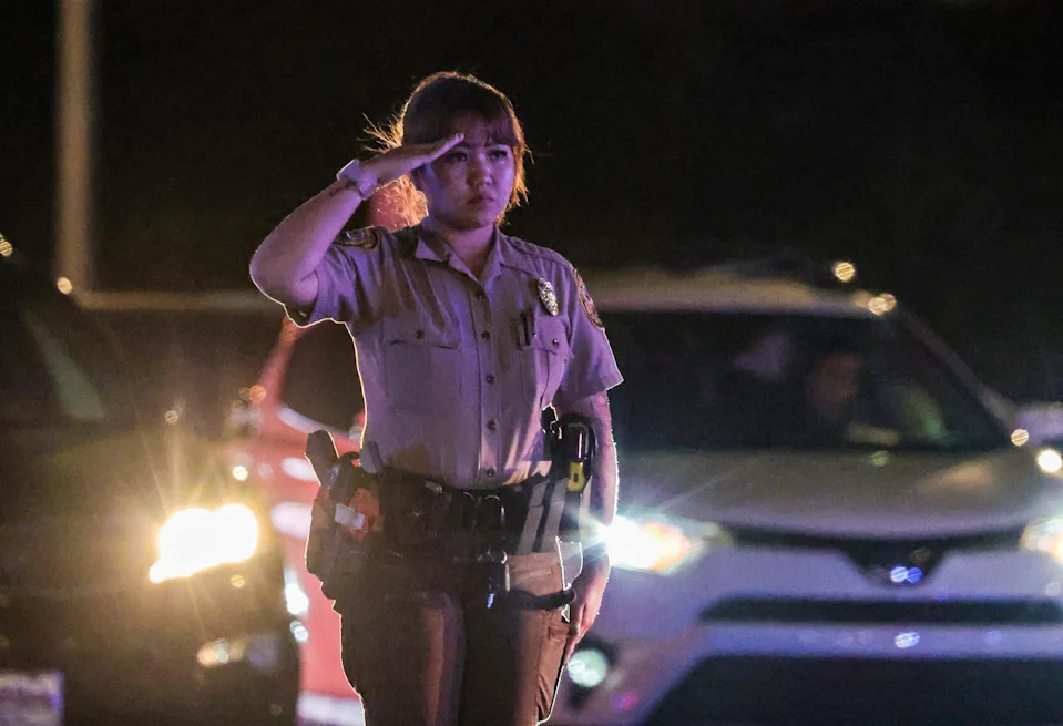 Police officers saluted the procession carrying the body of Miami-Dade Deputy Devin Jaramillo is escorted by several law enforcement officers with the motorcycle unit out of the HCA Florida Kendall Hospital. After he was ambushed as he responded to a traffic accident and was shot to death, on Friday November 07, 2025.