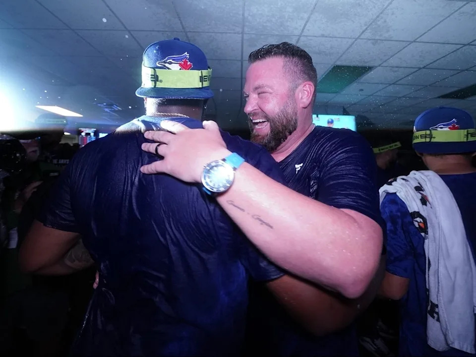  Vladimir Guerrero Jr., left, and manager John Schneider of the Toronto Blue Jays celebrate after clinching a playoff berth at Kauffman Stadium on Sunday, Sept. 21, 2025, in Kansas City, Mo.