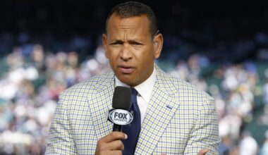 Alex Rodriguez holding a microphone
