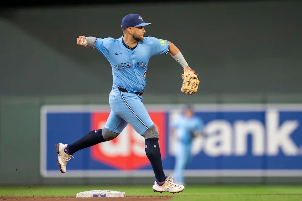 Jun 6, 2025; Minneapolis, Minnesota, USA; Toronto Blue Jays shortstop Bo Bichette (11) throws the ball to first base for an out against the Minnesota Twins in the fifth inning at Target Field. Mandatory Credit: Jesse Johnson-Imagn Images