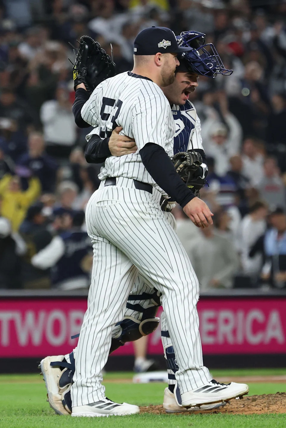 Oct 2, 2025; Bronx, New York, USA; New York Yankees pitcher David Bednar (53) and catcher Austin Wells (28) react after game three of the Wildcard round for the 2025 MLB playoffs against the Boston Red Sox at Yankee Stadium. Mandatory Credit: Vincent Carchietta-Imagn Images
