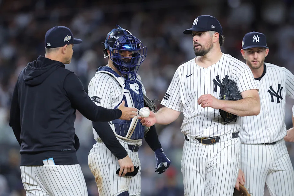 New York Yankees starting pitcher Carlos Rodon (55) leaves the mound as manager Aaron Boone (17) makes a pitching change against the Boston Red Sox.© Brad Penner-Imagn Images