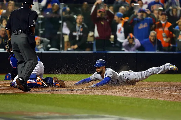 NEW YORK, NY – NOVEMBER 01: Eric Hosmer #35 of the Kansas City Royals scores a run off of a grounded out hit by Salvador Perez #13 to tie the game in the ninth inning against Jeurys Familia #27 of the New York Mets during Game Five of the 2015 World Series at Citi Field on November 1, 2015 in the Flushing neighborhood of the Queens borough of New York City. (Photo by Elsa/Getty Images)