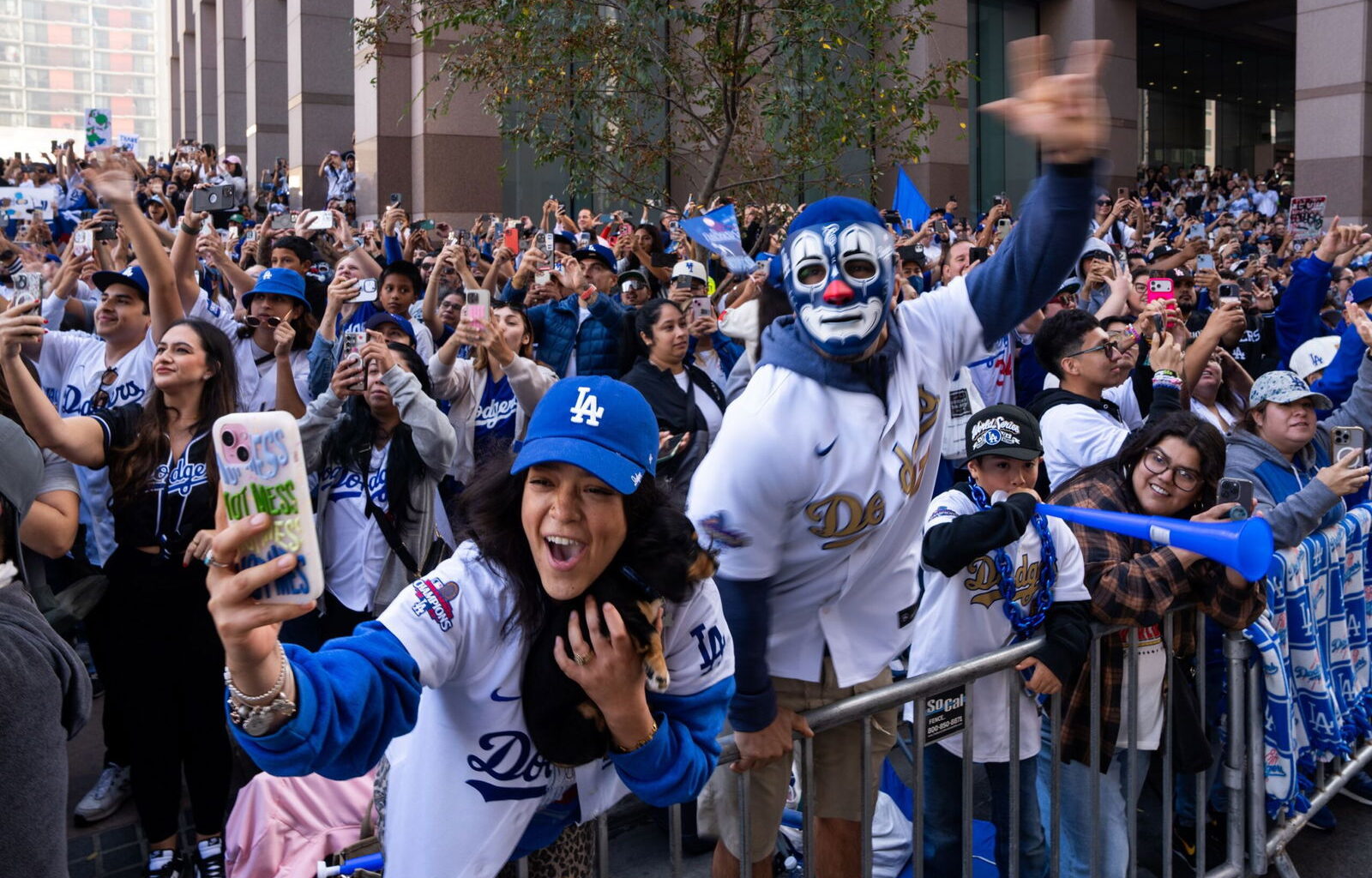 Wayne Qien/VCGPIX/AP via CNN NewsourceFans cheer along the route during the Los Angeles Dodgers