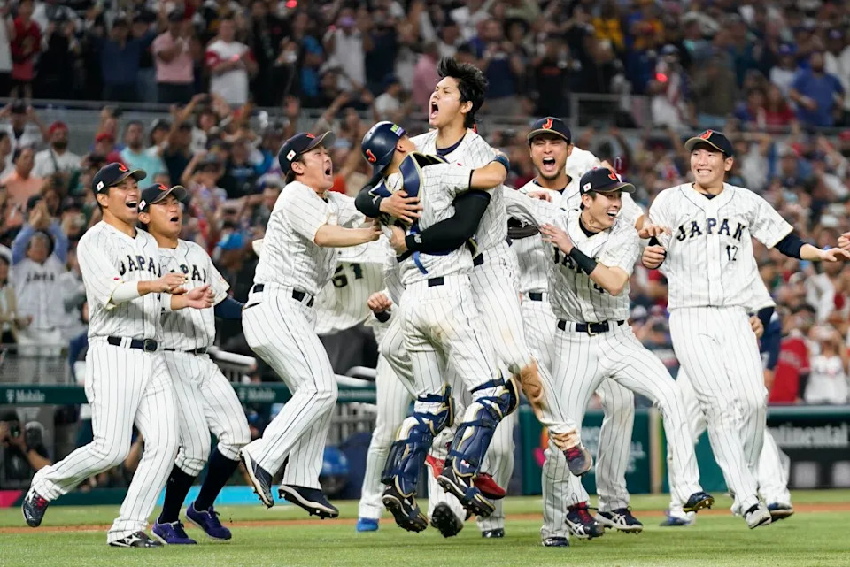 Shohei Ohtani celebrates with his teammates after striking out Mike Trout.