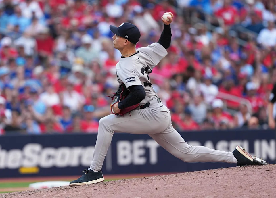 Jul 1, 2025; Toronto, Ontario, CAN; New York Yankees relief pitcher Luke Weaver (30) throws a pitch against the Toronto Blue Jays during the seventh inning at Rogers Centre. Mandatory Credit: Nick Turchiaro-Imagn Images