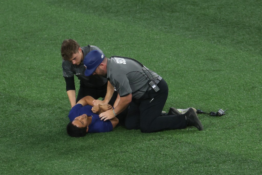 A fan being tackled by security on the field during the World Series.
