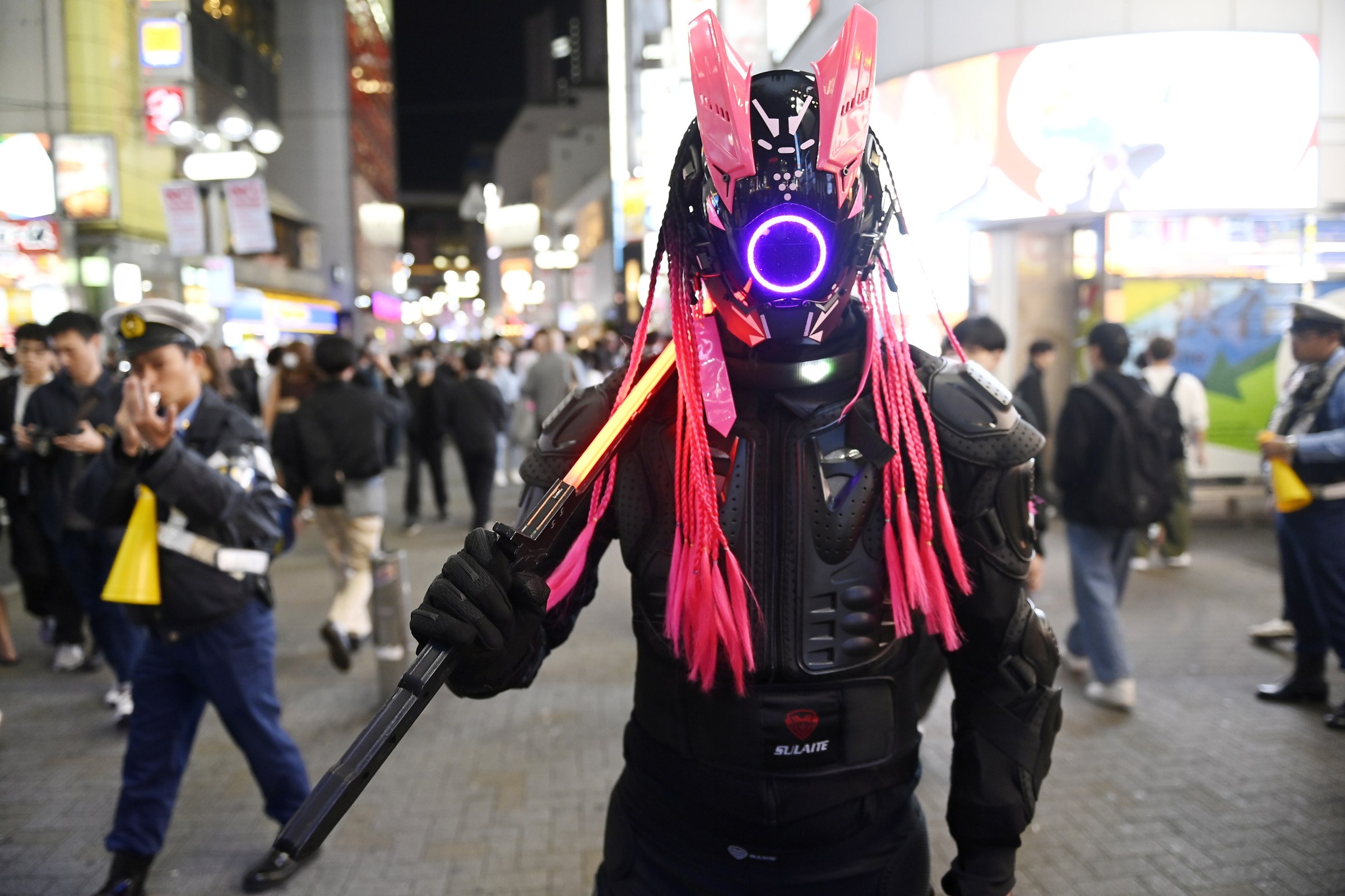 TOKYO, JAPAN - OCTOBER 31: People, wearing fancy costumes, walk on the street as they celebrate Halloween night, despite the ban on celebrating the event, in the popular Shibuya district of Tokyo, Japan on October 31, 2024. (Photo by David Mareuil/Anadolu via Getty Images)