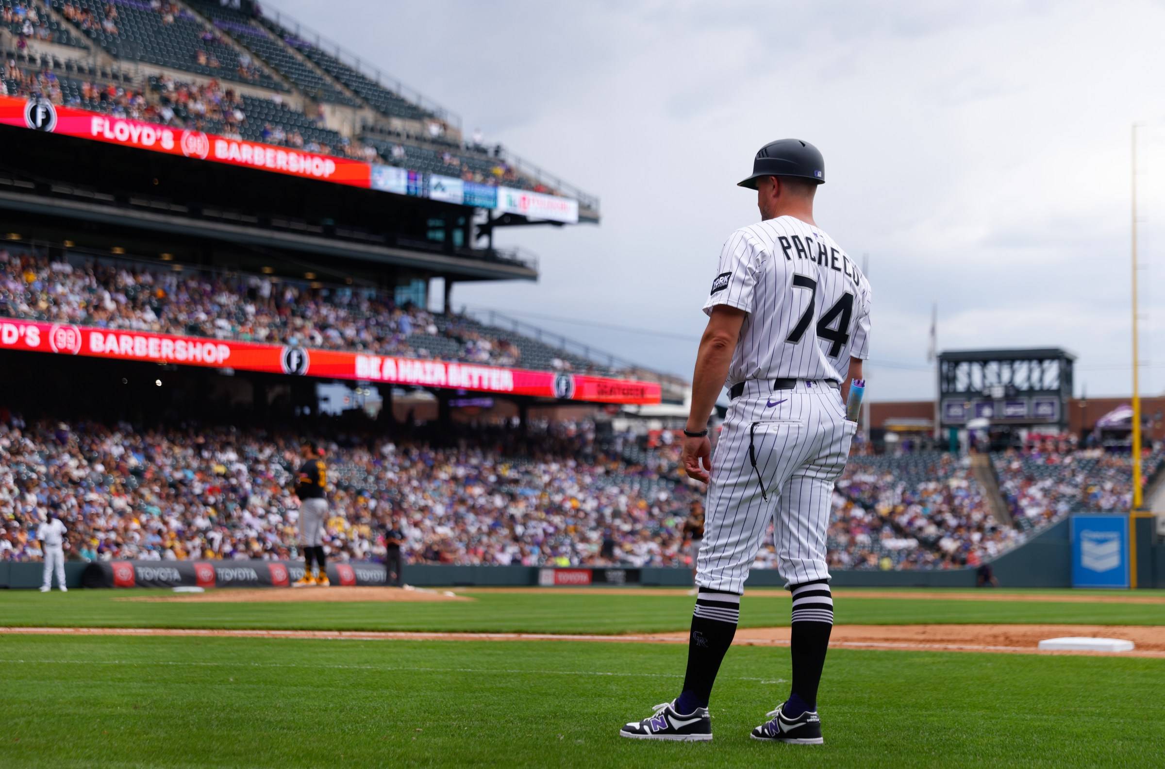 DENVER, CO - AUGUST 2: Jordan Pacheco #74 of the Colorado Rockies coaches first base in the sixth inning against the Pittsburgh Pirates at Coors Field on August 2, 2025 in Denver, Colorado. (Photo by Justin Edmonds/Getty Images)