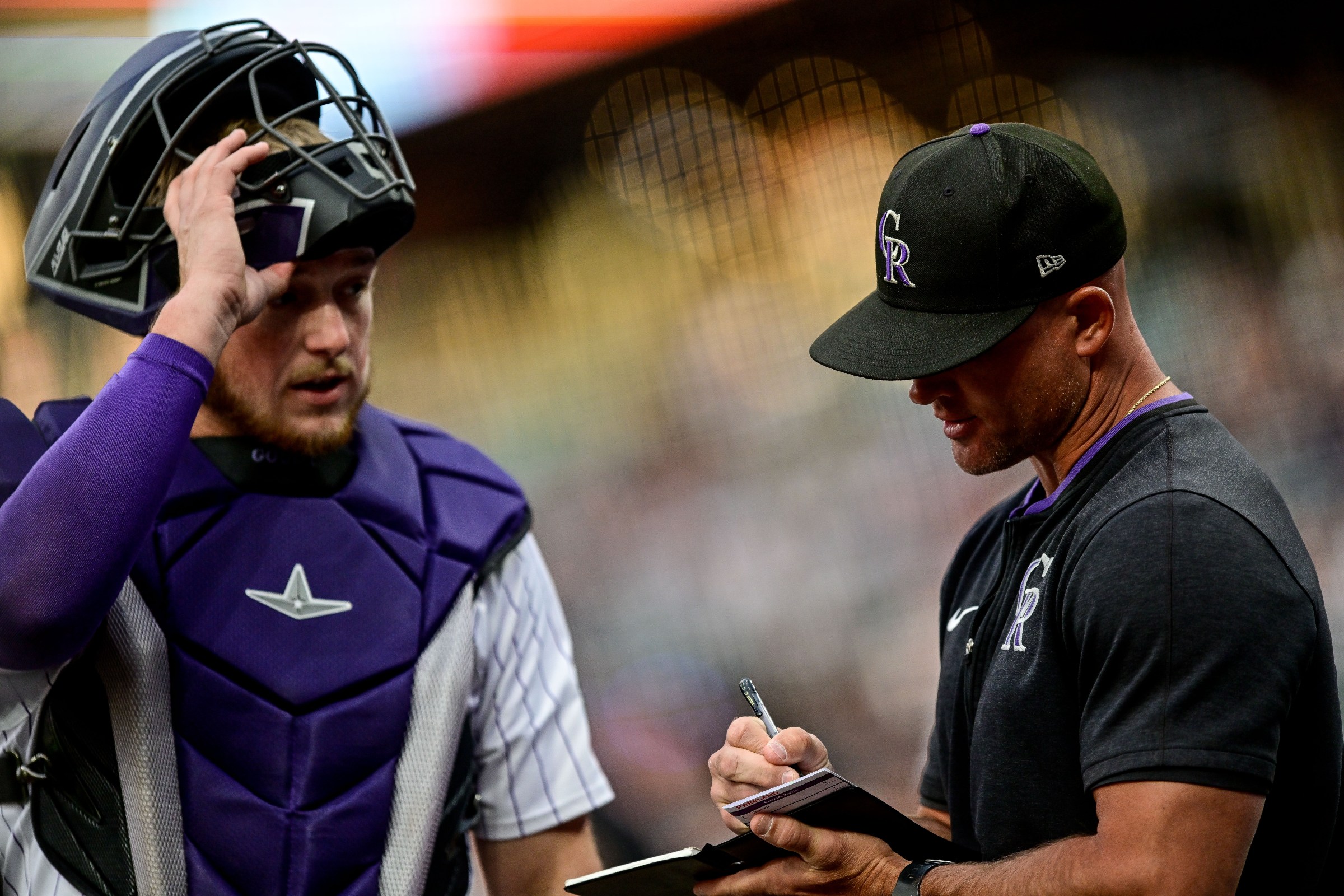 DENVER, CO - SEPTEMBER 2: Colorado Rockies interim manager Warren Schaeffer (34) and catcher Hunter Goodman (15) look on during a delay in the first inning during a game between the San Francisco Giants and the Colorado Rockies at Coors Field on September 2, 2025 in Denver, Colorado. (Photo by Dustin Bradford/Icon Sportswire via Getty Images)