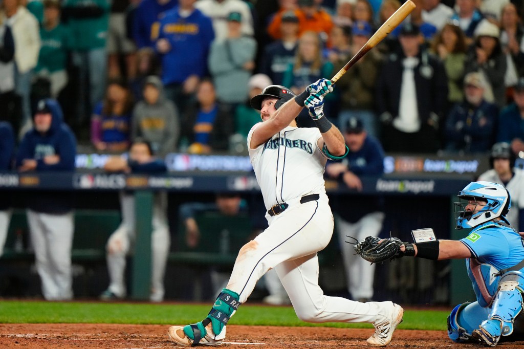 Seattle Mariners catcher Cal Raleigh hitting a solo home run against the Toronto Blue Jays.