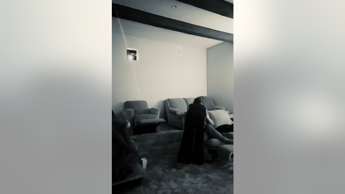 Meghan Markle kissing Prince Harry in their theater room. 