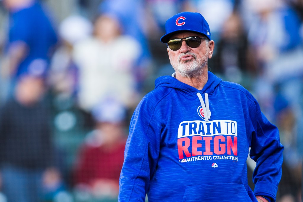 Chicago Cubs manager Joe Maddon in a blue hoodie and cap with sunglasses.