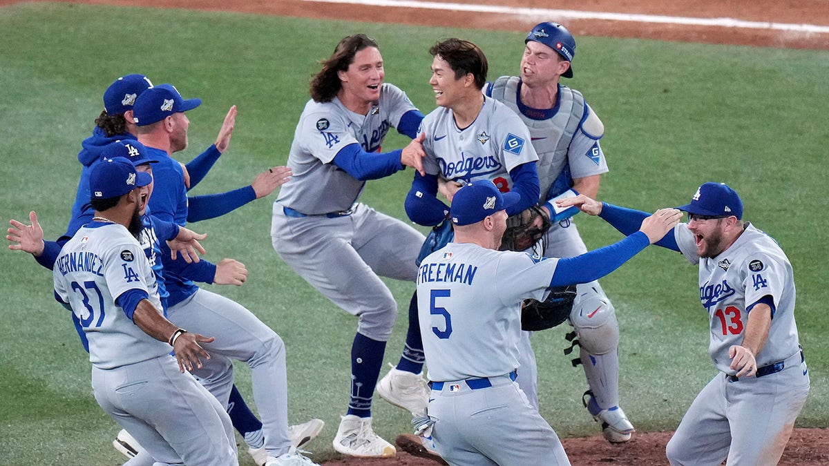 Los Angeles Dodgers pitcher Yoshinobu Yamamoto (18) celebrates with teammates after the team defeated the Toronto Blue Jays in Game 7 of baseball's World Series, Sunday, Nov. 2, 2025, in Toronto. 