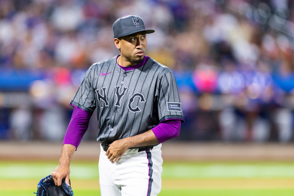 New York Mets pitcher Edwin Díaz walks off the field after the ninth inning.