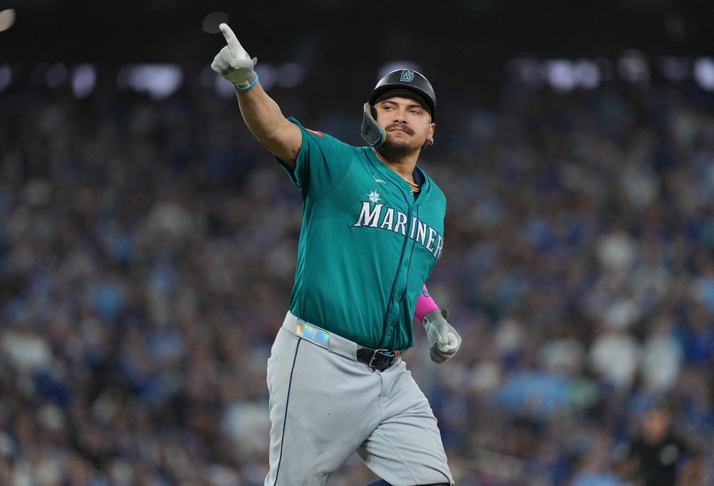 Seattle Mariners first baseman Josh Naylor points to the sky after hitting a home run.