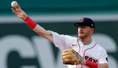 FILE - Boston Red Sox infielder Trevor Story throws to first base on the force out single by Texas Rangers' Marcus Semien during the third inning of a baseball game, Sept. 3, 2022, in Boston. Story thinks he can return to the lineup in July 2023 as the team’s designated hitter. Recovering from surgery in January on his injured right elbow, Story is in Boston working out with the Red Sox after doing much of his rehab work at the team’s complex in Fort Myers, Fla. (AP Photo/Michael Dwyer, File)