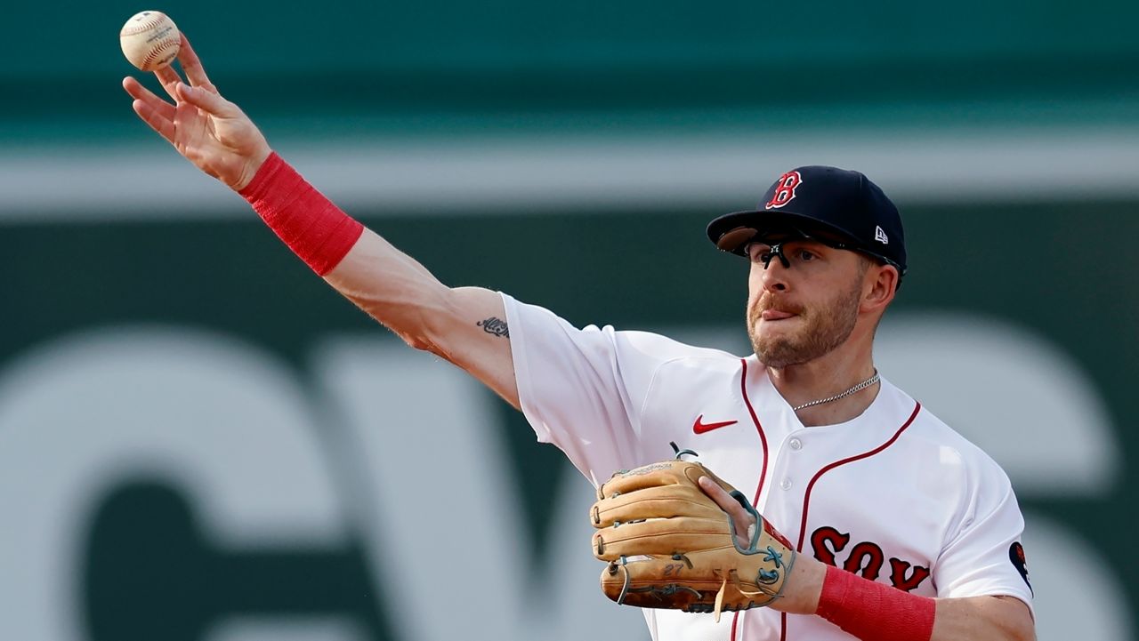 FILE - Boston Red Sox infielder Trevor Story throws to first base on the force out single by Texas Rangers' Marcus Semien during the third inning of a baseball game, Sept. 3, 2022, in Boston. Story thinks he can return to the lineup in July 2023 as the team’s designated hitter. Recovering from surgery in January on his injured right elbow, Story is in Boston working out with the Red Sox after doing much of his rehab work at the team’s complex in Fort Myers, Fla. (AP Photo/Michael Dwyer, File)