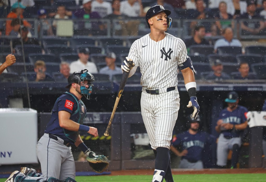 New York Yankees outfielder Aaron Judge (99) strikes out swinging in the rain.