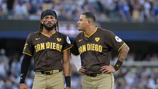 Oct 6, 2024; Los Angeles, California, USA; San Diego Padres outfielder Fernando Tatis Jr. (23) and third baseman Manny Machado (13) look on in the third inning against the Los Angeles Dodgers during game two of the NLDS for the 2024 MLB Playoffs at Dodger Stadium. 