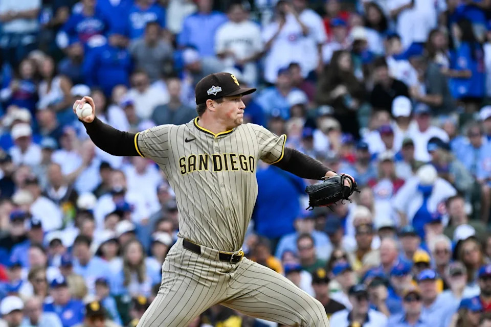 Oct 1, 2025; Chicago, Illinois, USA; San Diego Padres pitcher Mason Miller (22) delivers during the seventh inning against the Chicago Cubs during game two of the Wildcard round for the 2025 MLB playoffs at Wrigley Field. Mandatory Credit: Matt Marton-Imagn Images
