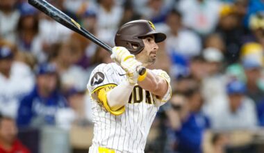 Jun 9, 2025; San Diego, California, USA; San Diego Padres left fielder Tyler Wade (14) hits a three run triple during the third inning against the Los Angeles Dodgers at Petco Park. Mandatory Credit: David Frerker-Imagn Images