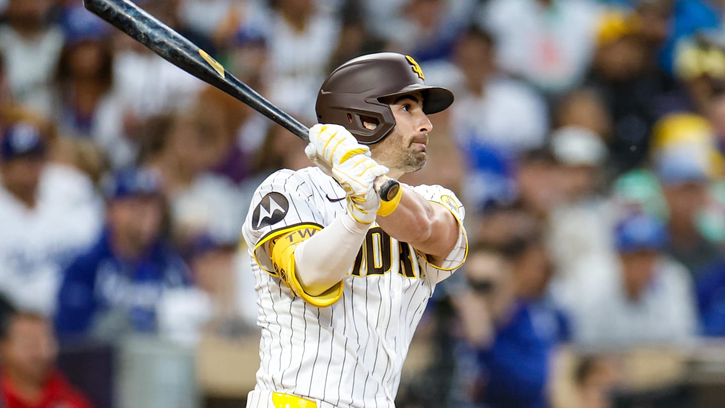 Jun 9, 2025; San Diego, California, USA; San Diego Padres left fielder Tyler Wade (14) hits a three run triple during the third inning against the Los Angeles Dodgers at Petco Park. Mandatory Credit: David Frerker-Imagn Images