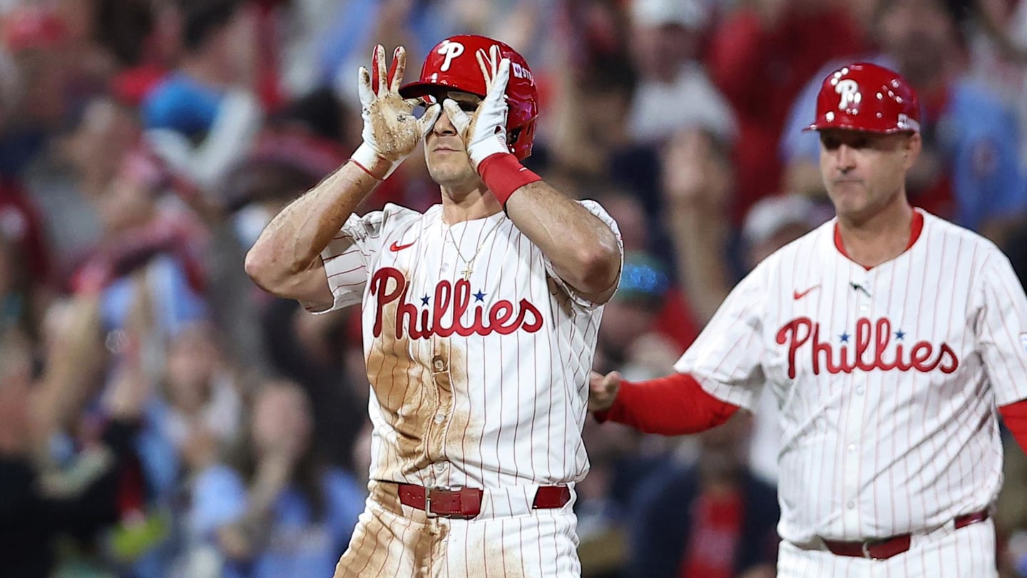 Oct 4, 2025; Philadelphia, Pennsylvania, USA; Philadelphia Phillies catcher J.T. Realmuto (10) reacts after hitting a two RBI triple against the Los Angeles Dodgers in the second inning during game one of the NLDS round for the 2025 MLB playoffs at Citizens Bank Park.