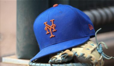 Jul 13, 2022; Atlanta, Georgia, USA; A detailed view of a New York Mets hat and glove in the dugout against the Atlanta Braves in the eighth inning at Truist Park. Mandatory Credit: Brett Davis-Imagn Images