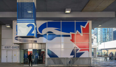 A person walking past a Blue Jays MLB team exhibit inside...