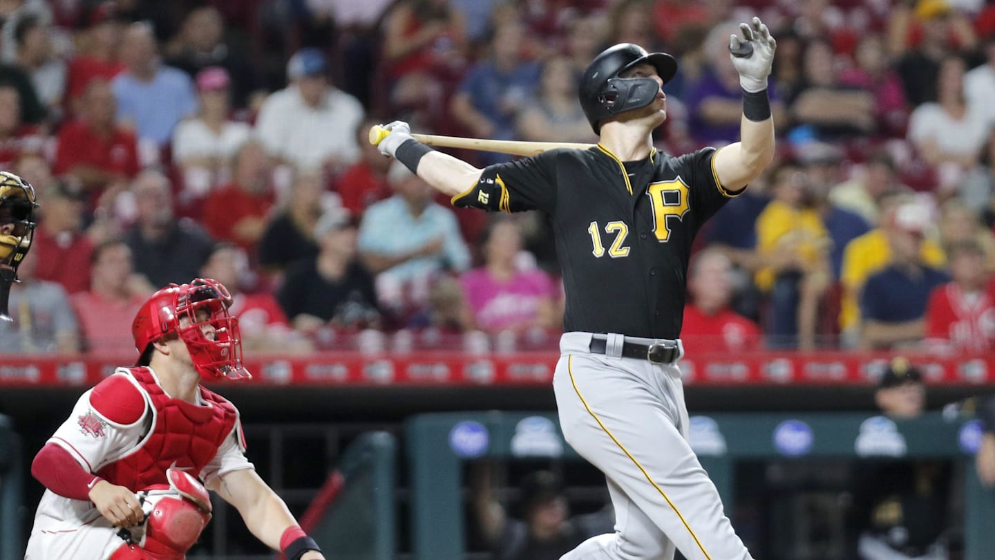 Jul 30, 2019; Cincinnati, OH, USA; Pittsburgh Pirates left fielder Corey Dickerson (12) follows through on a swing for a solo home run against the Cincinnati Reds during the seventh inning at Great American Ball Park. Mandatory Credit: David Kohl-Imagn Images