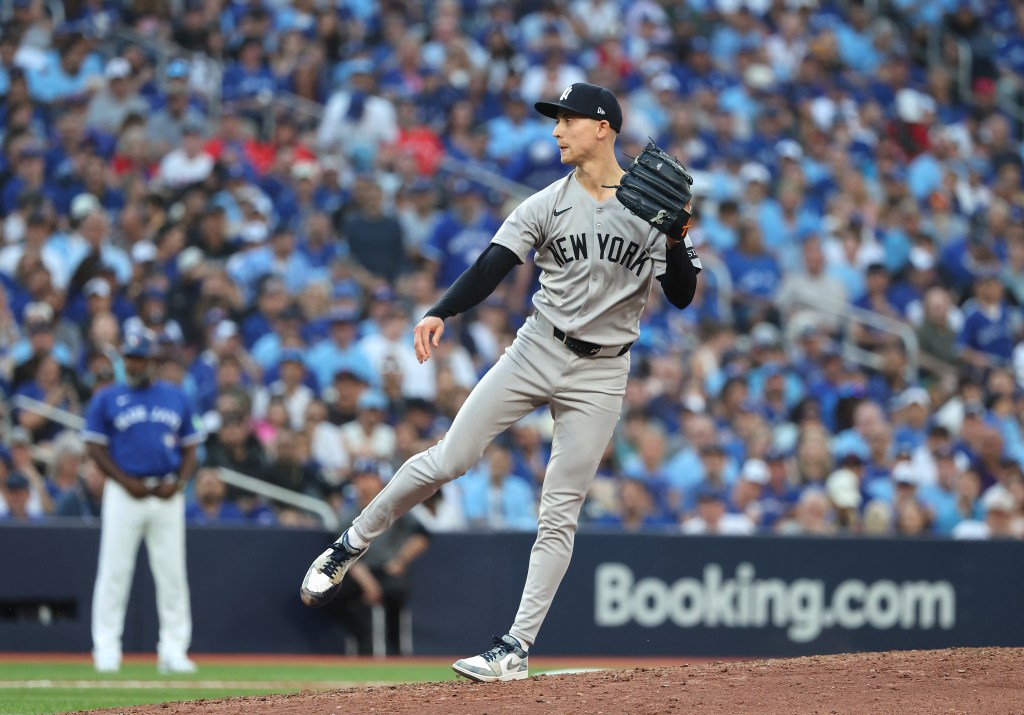 New York Yankees pitcher Luke Weaver in mid-pitch during the 7th inning.