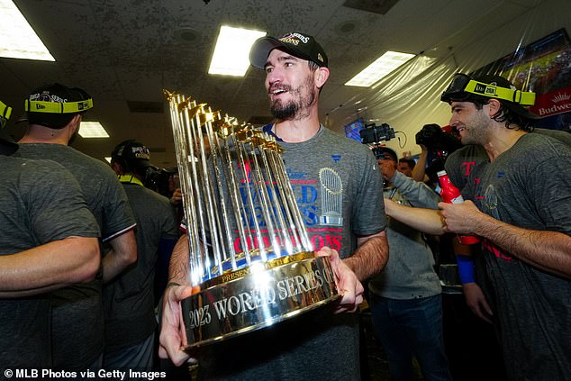 The pitcher celebrates in the locker room at Chase Field after winning the 2023 World Series