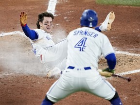 Ernie Clement of the Toronto Blue Jays slides across home plate to score a run during the sixth inning against the Los Angeles Dodgers in game seven of the 2025 World Series.