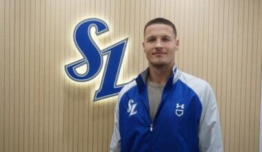 New Samsung Lions pitcher Matt Manning poses in front of the team's logo at Daegu Samsung Lions Park in the southeastern city of Daegu, Monday, in this photo provided by the Lions. Yonhap