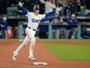 Los Angeles Dodgers' Freddie Freeman celebrates his walk off home run against the Toronto Blue Jays during the 18th inning in Game 3 of the World Series.


