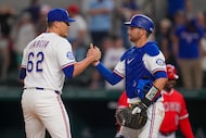 Texas Rangers pitcher Robert Garcia, left, and catcher Kyle Higashioka react at the end of a...