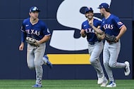 From left to right, Texas Rangers' Wyatt Langford, Evan Carter and Josh Smith celebrate...