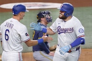 Texas Rangers first base Jake Burger (21) gets a high-five from his teammate  Josh Jung (6)...