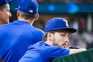 Texas Rangers outfielder Evan Carter watches from the dugout during the sixth inning of a...